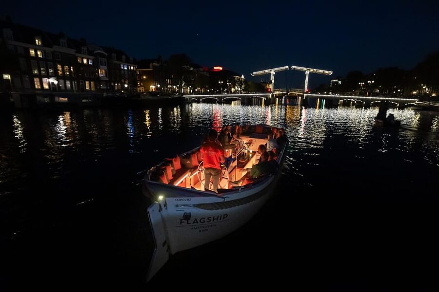 Amsterdam: Evening Canal Cruise with (Open) Bar on Board - Amsterdam after dark from a low canal boat