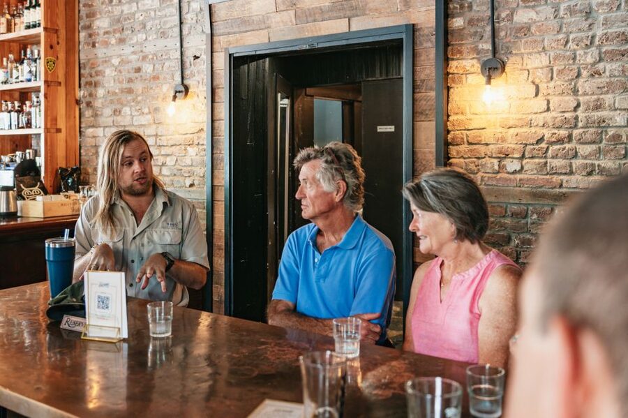 Charleston: Speakeasy Sagas Prohibition Pub Crawl - Hearing the guide in a busy bar