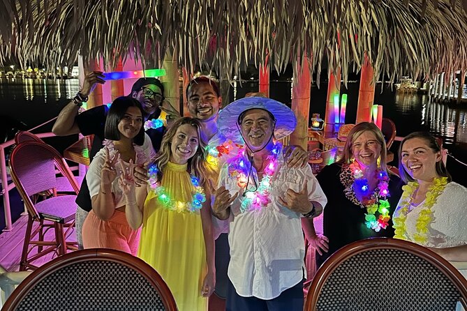 Original CRUISIN' TIKIS Lit on the Lagoon- A Glow Tiki Bar Cruise - A glowing tiki hut after dark