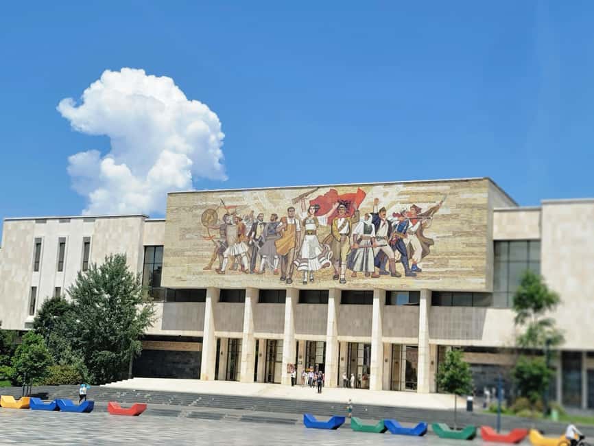Tirana by Night: Walking Tour with Cocktail & City Lights - Starting under the lights at Skanderbeg Square
